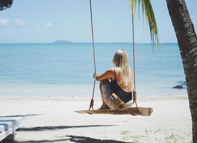 Lux* Grand Gaube Resort & Villas Exterior photo A woman on a swing